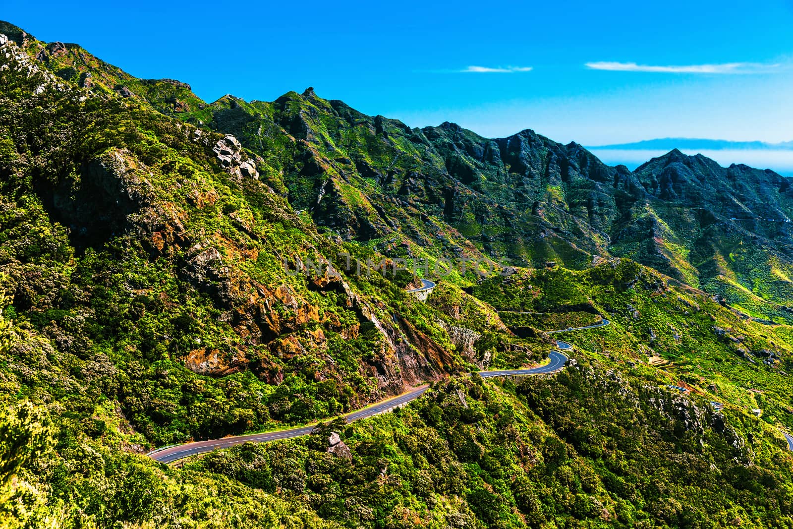 Green mountains or rocks valley with winding road and sky nature landscape in Tenerife Canary island, Spain at summer or spring