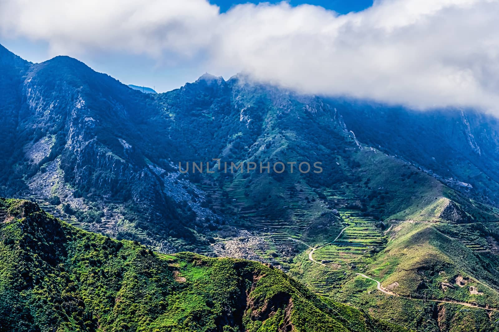 Green mountains with clouds on sky landscape in Tenerife island, Spain
