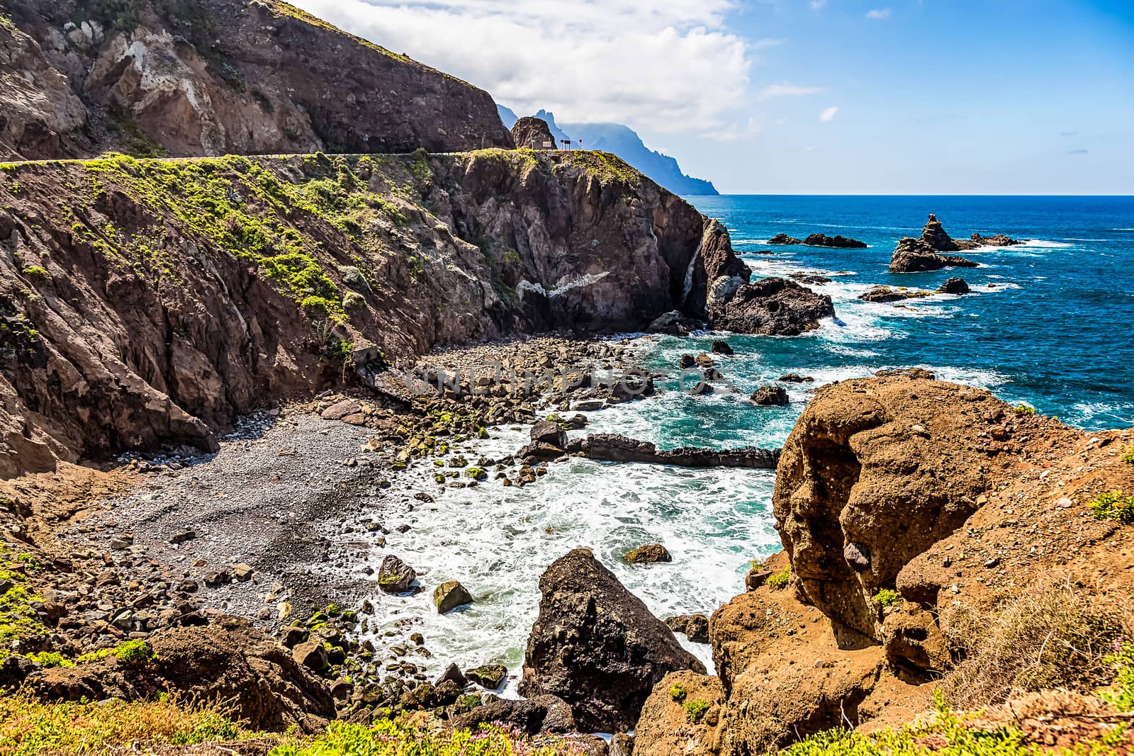 Coast or shore of Atlantic ocean with  mountain or rock and blue sky with clouds and horizon in Tenerife Canary island, Spain at spring or summer