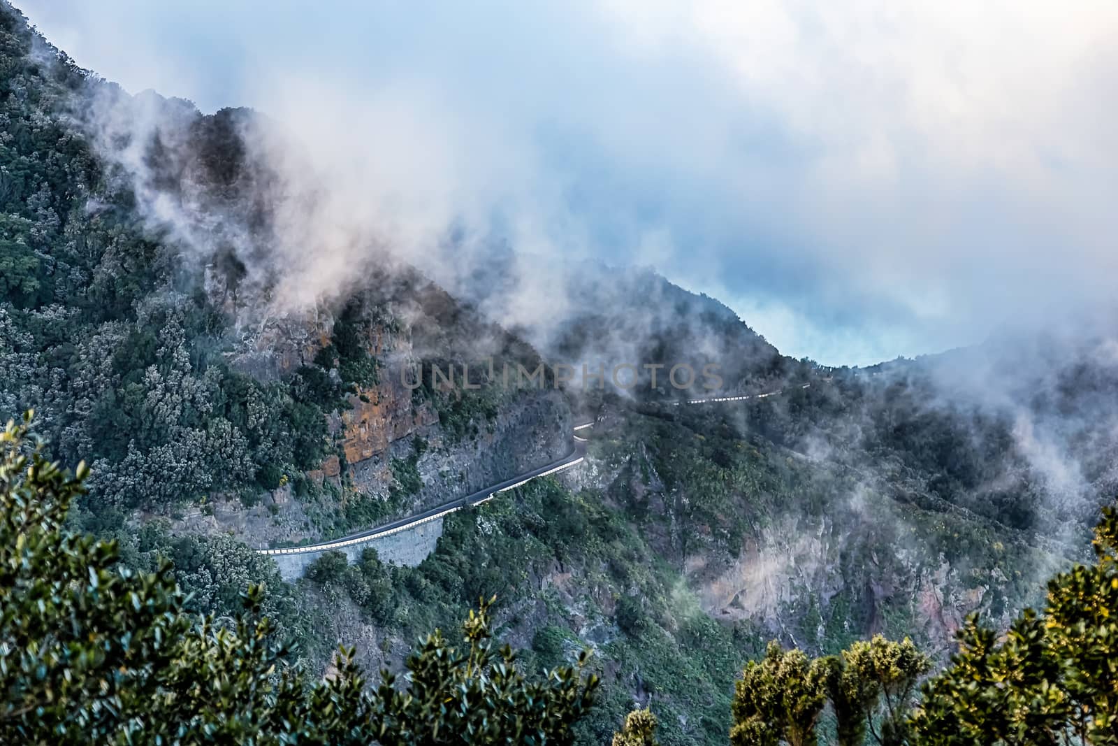 Clouds over mountain landscape with winding road in Tenerife Canary island, Spain
