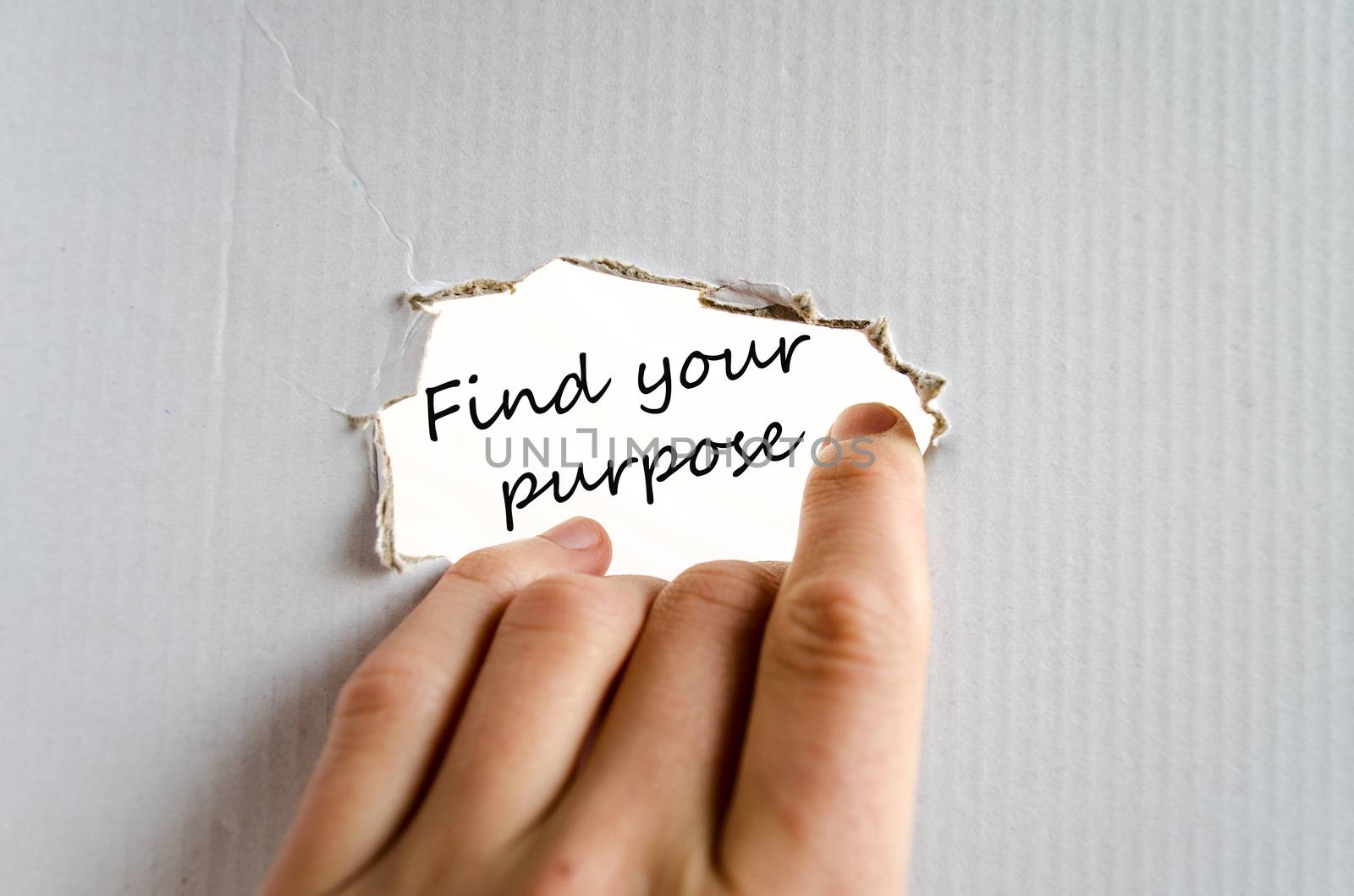 Hand and text on the cardboard background Find your purpose