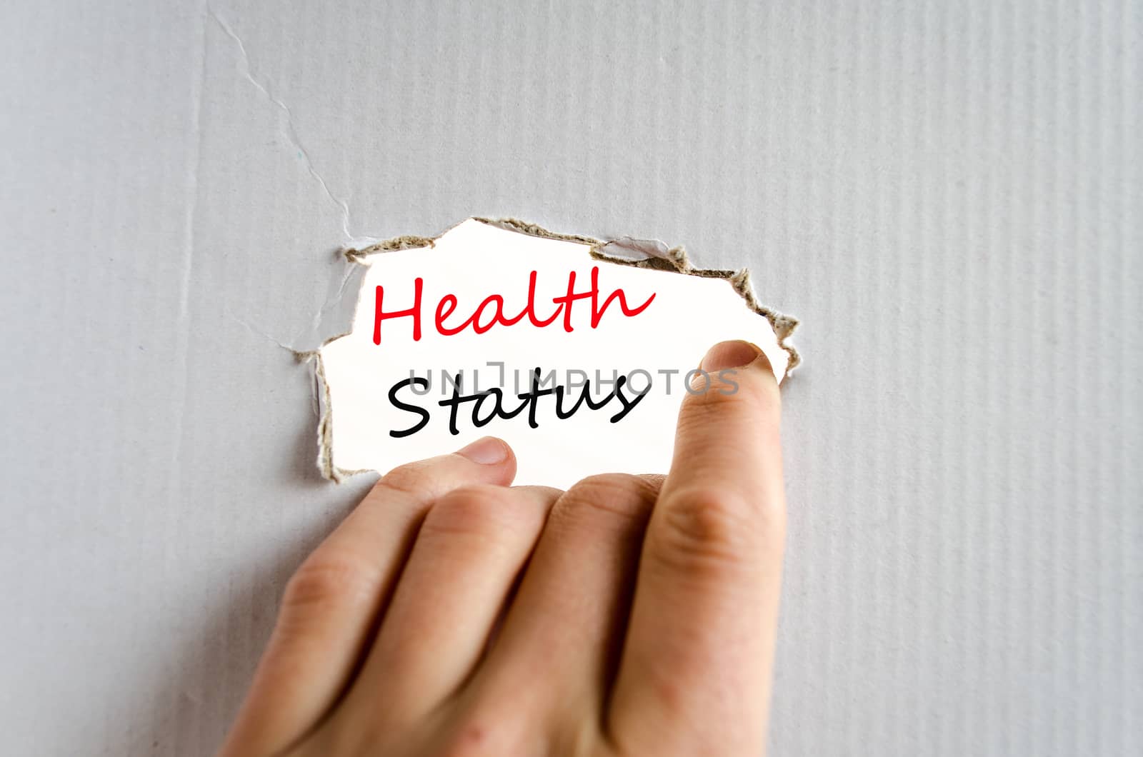 Hand and text on the cardboard background Health Status