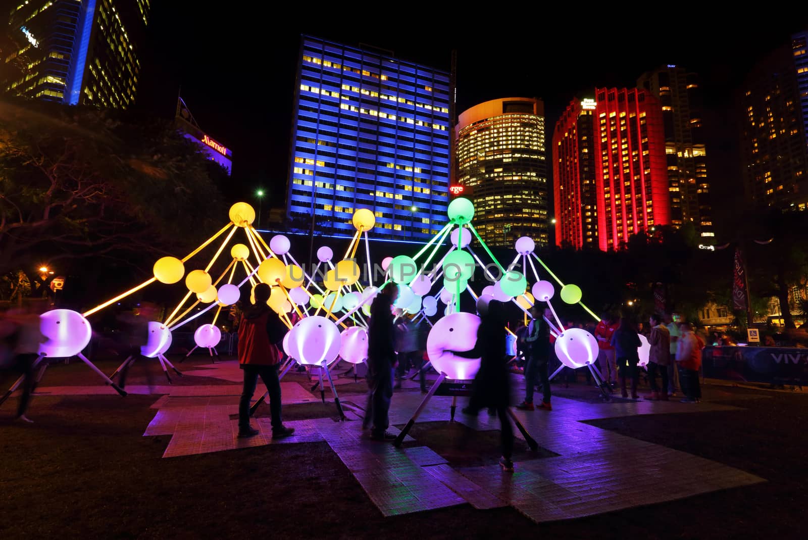 SYDNEY, AUSTRALIA, MAY 25, 2015:  Tourists and local public enjoy the Affinity installation at Vivid Sydney, which  depict the dazzling complexity and connectivity of the human brain and neurons.  When stimulated by touch, the orbs set-up a striking display of sound and light.  People in motion.  Artists:  amigo & amigo (Simone Chua & Renzo B. Larriviere ) + S1T2 (Chris Panzetta & Naimul Khaled)