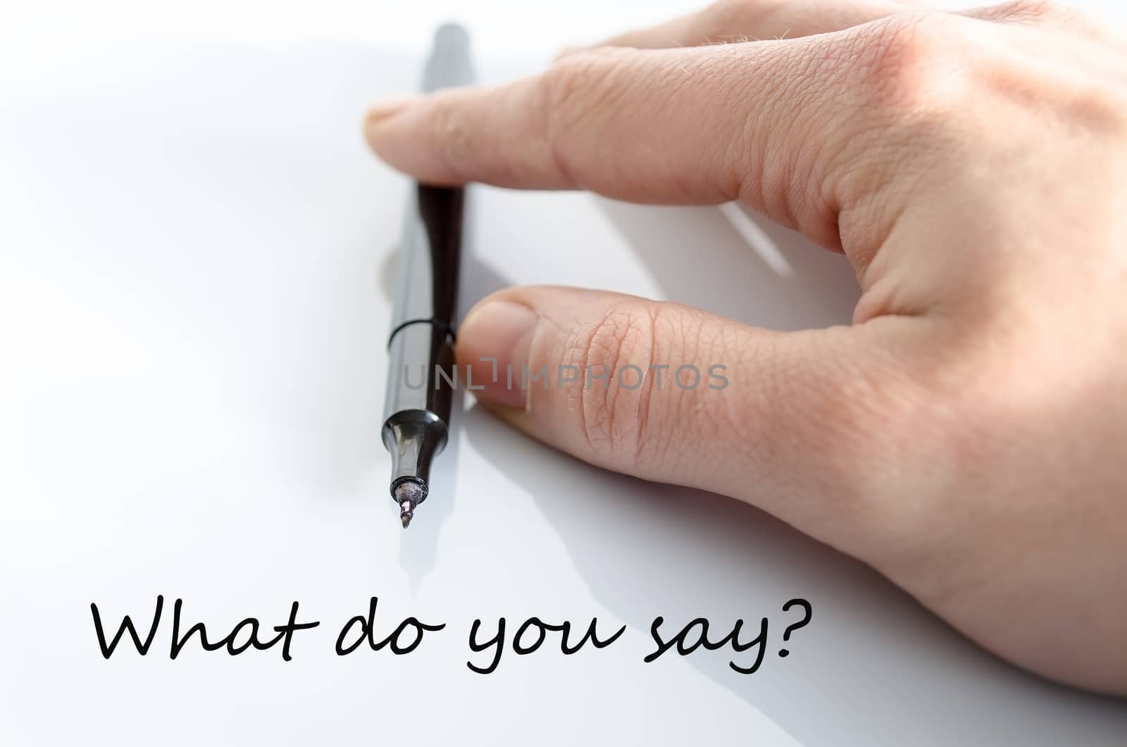 Pen in the hand isolated over white background What do you say concept