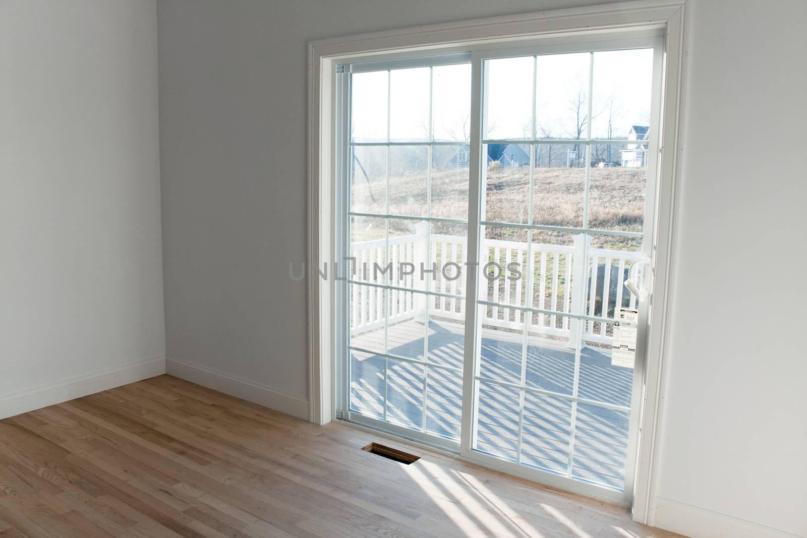 Modern home interior with sliding glass doors leading to a small porch.