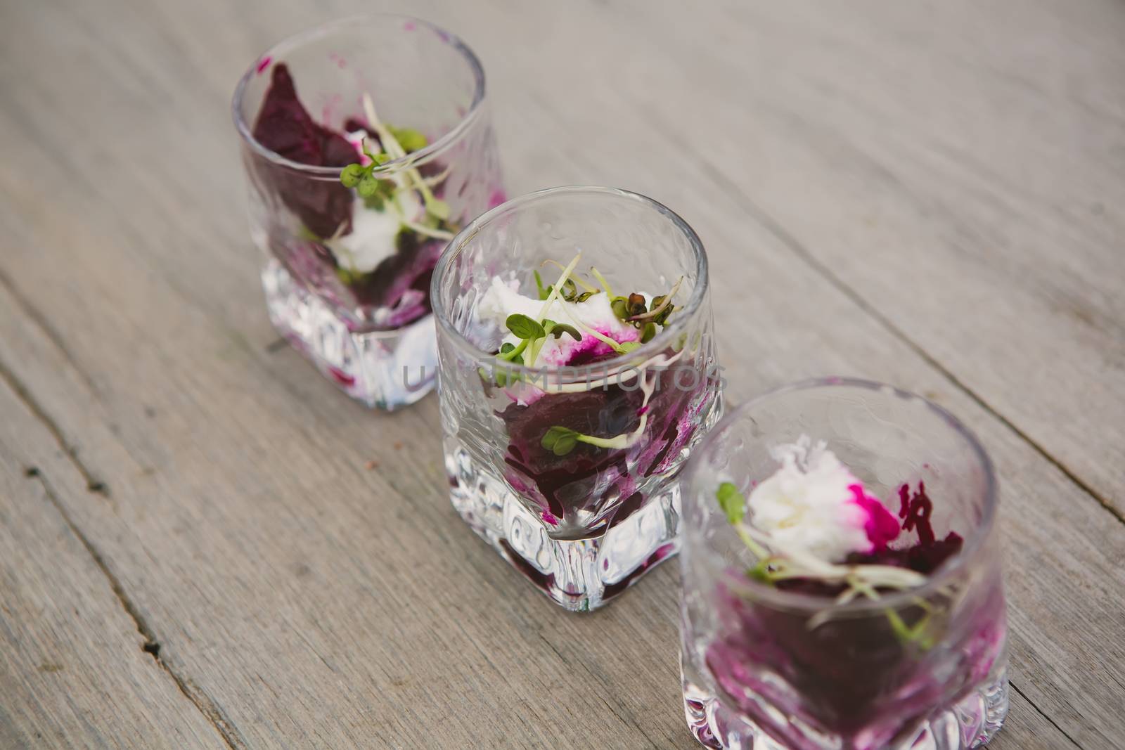 Vegetarian aperitif with beet, goat cheese and soy sprouts