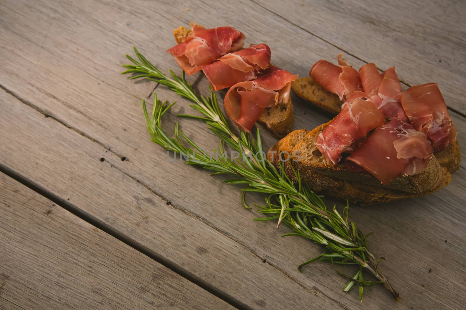 sliced prosciutto on a wooden board. Close up
