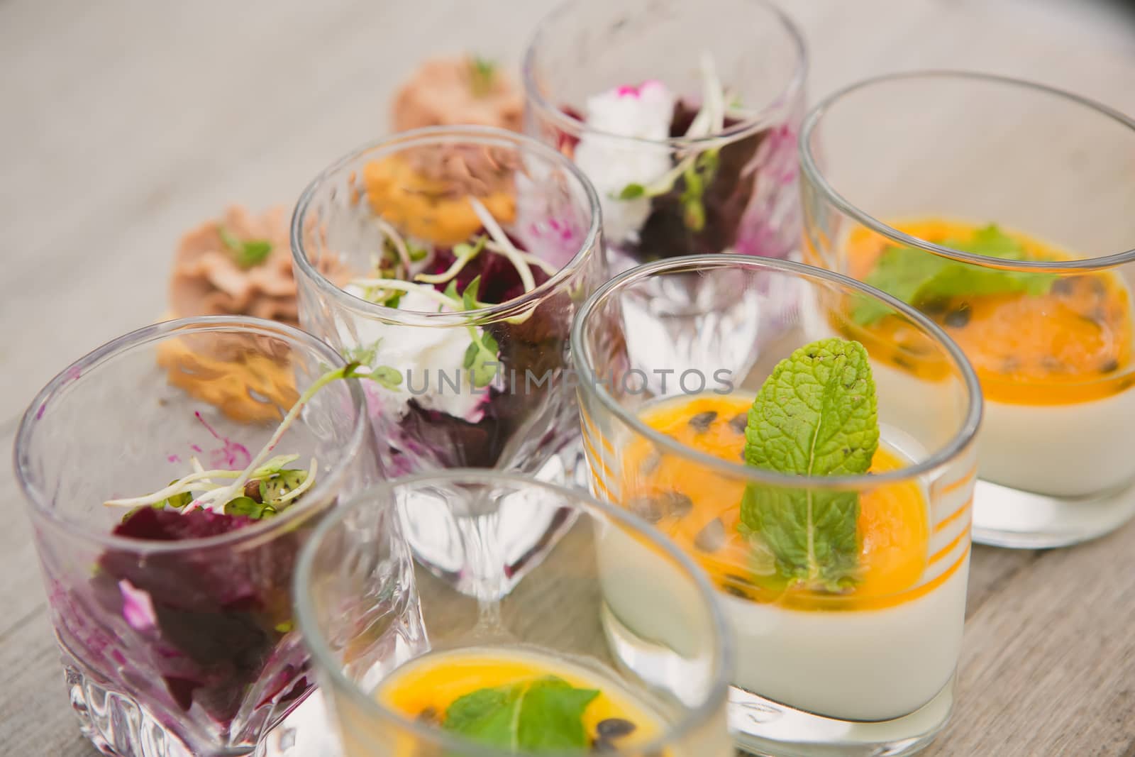 Catering. Salad in a glass on a wooden table