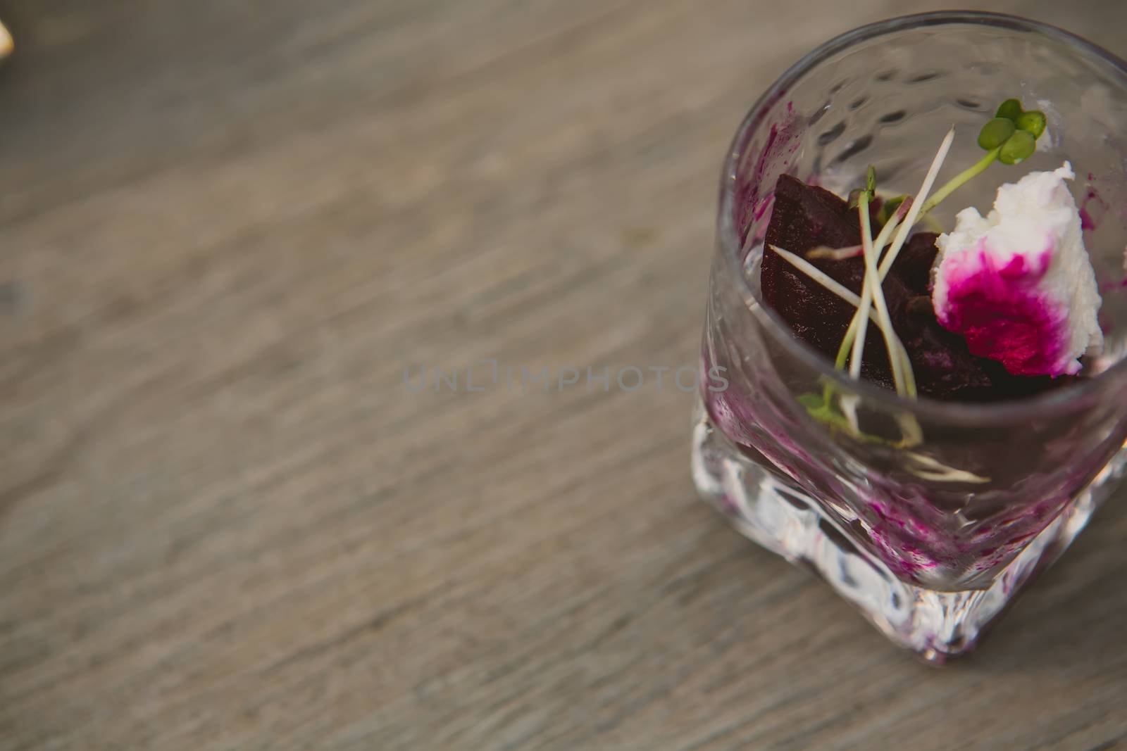 Vegetarian aperitif with beet, goat cheese and soy sprouts