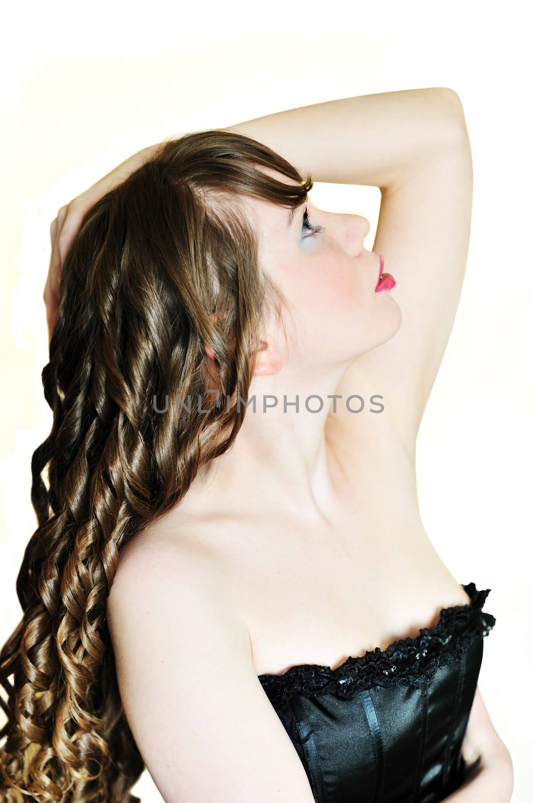 side face of curly longhaired girl over the white
