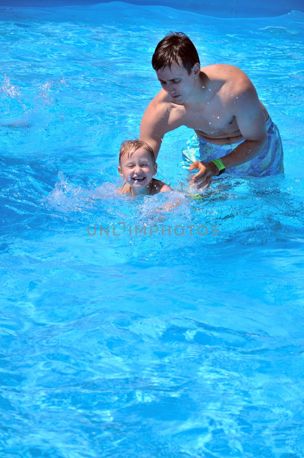 father teaching son to swim, he almost can do it