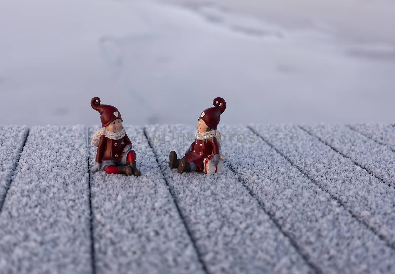 A jetty with two figures to symbolise christmas