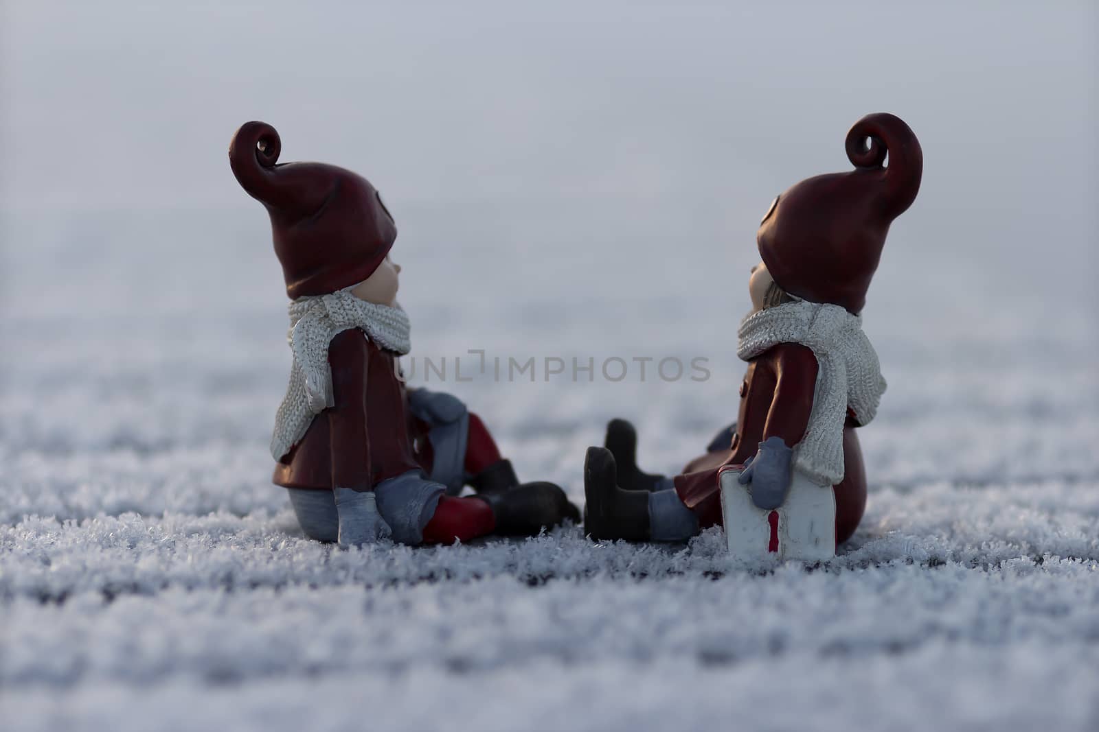 Two figures on a frosty pier waiting for the christmas