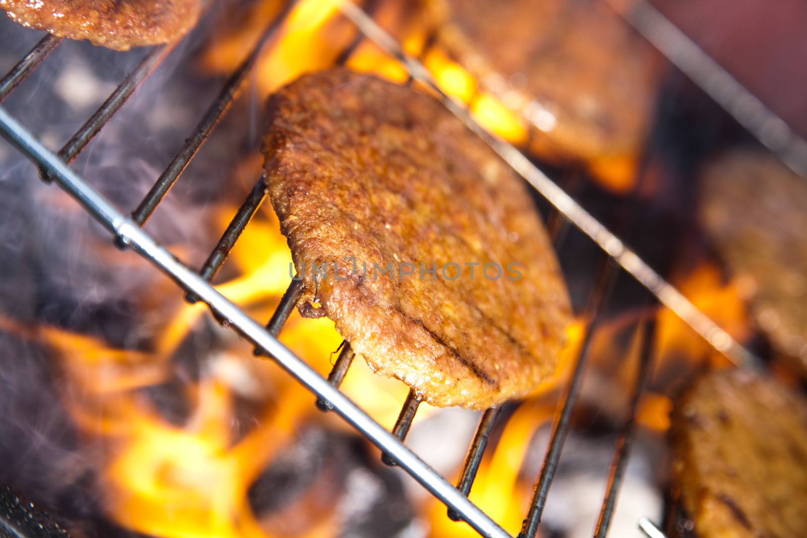 Grilling meat in flames, tasty dinner