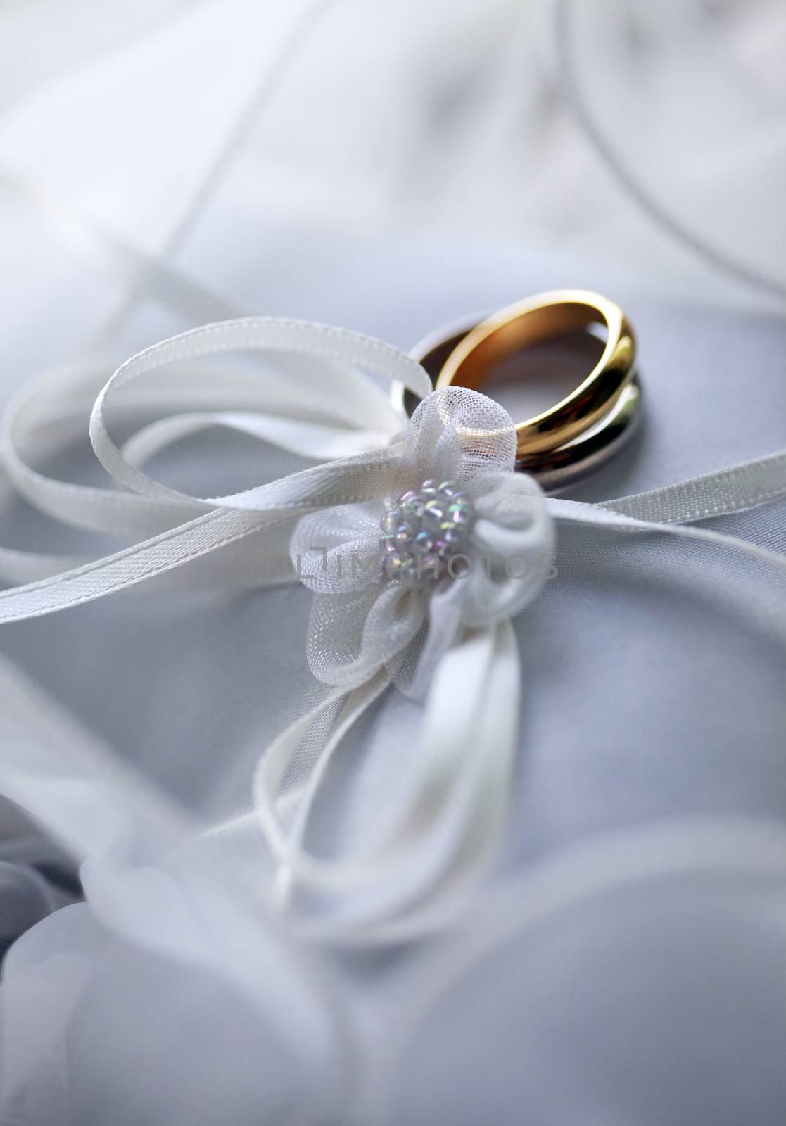 Wedding rings on a white satiny fabric