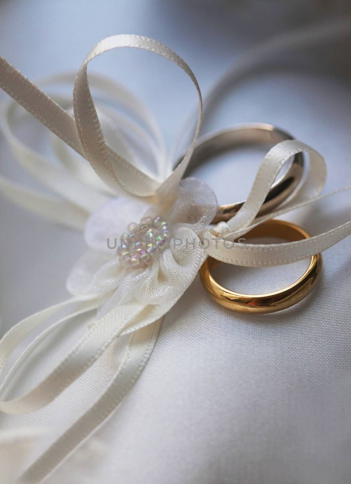 Wedding rings on a white satiny fabric