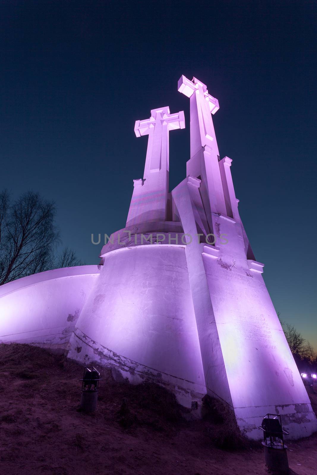 VILNIUS, LITHUANIA -March 19, 2015: Purple Illuminated Monument of Three Crosses on the Bleak Hill at the dawn time. It is one of main landmarks of Lithuania Capital city.