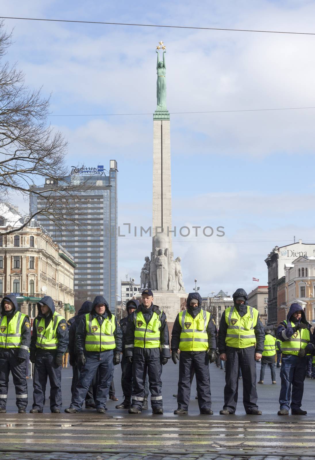 Police line infront Freedom Monument in Riga, Latvia by ints