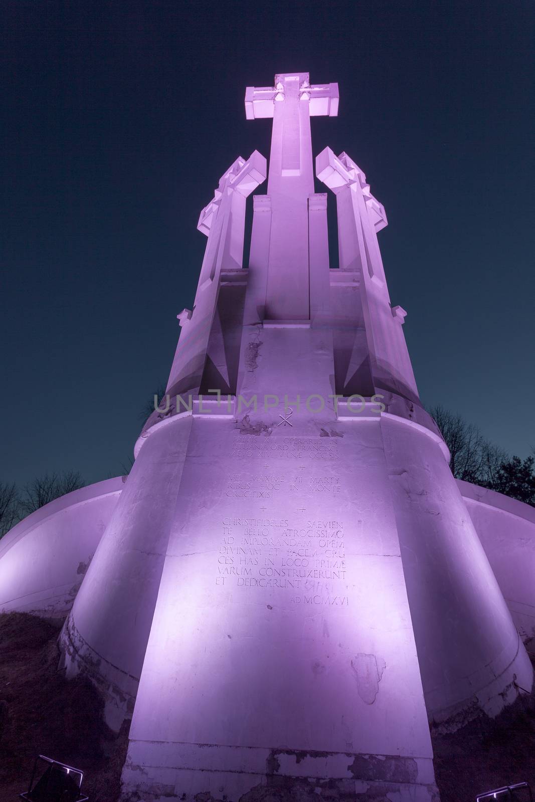 VILNIUS, LITHUANIA -March 19, 2015: Purple Illuminated Monument of Three Crosses on the Bleak Hill at the dawn time. It is one of main landmarks of Lithuania Capital city.