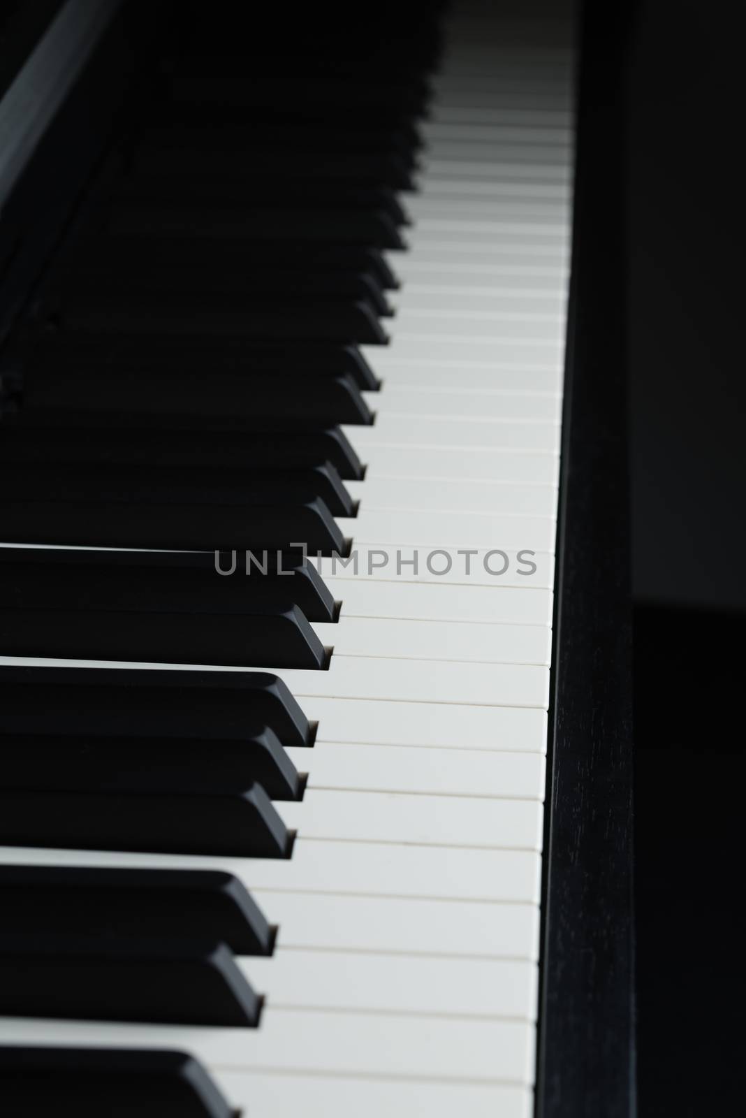 A dramatically dark picture of a piano's keyboard.