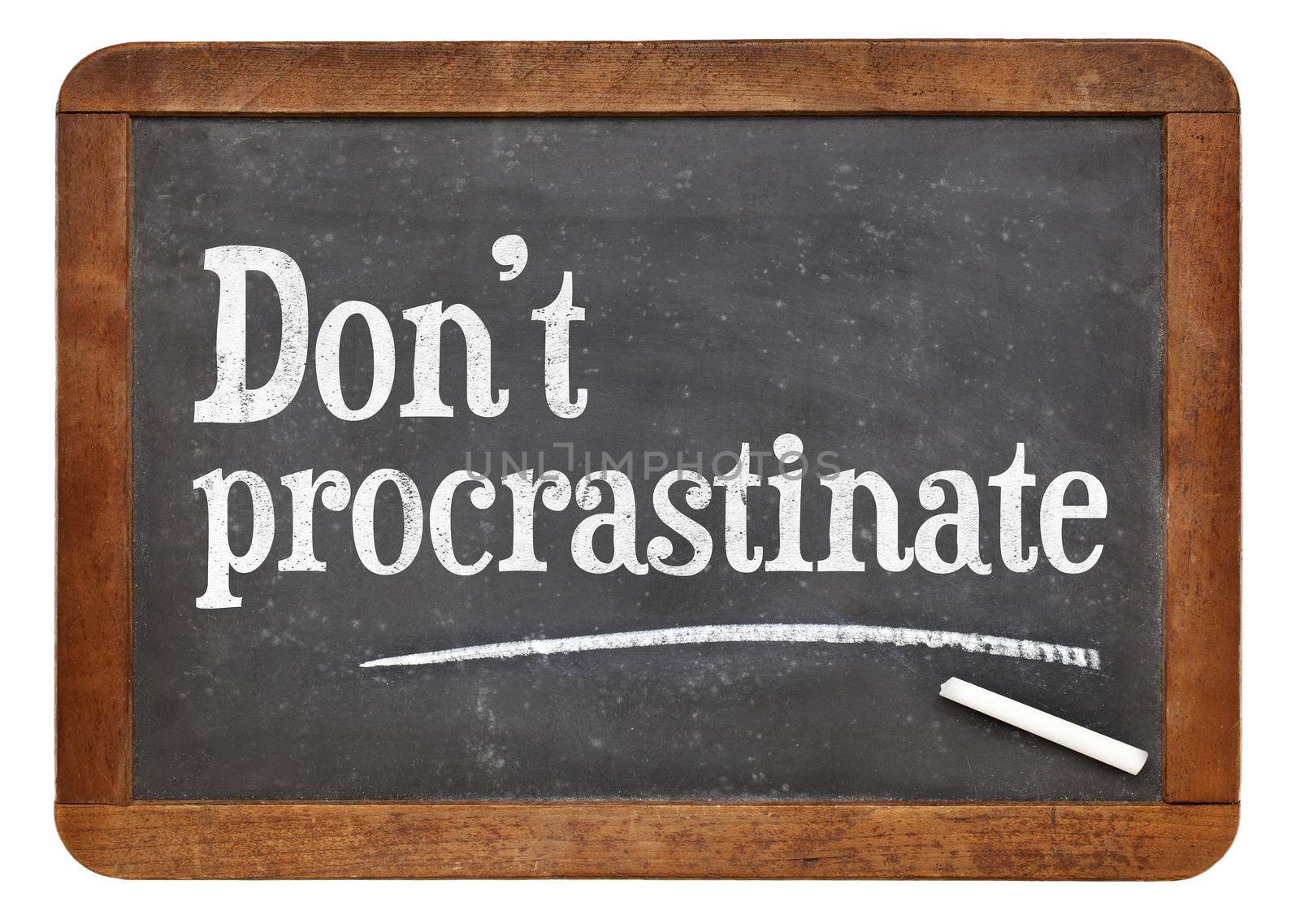 Do not procrastinate advice on a vintage slate blackboard