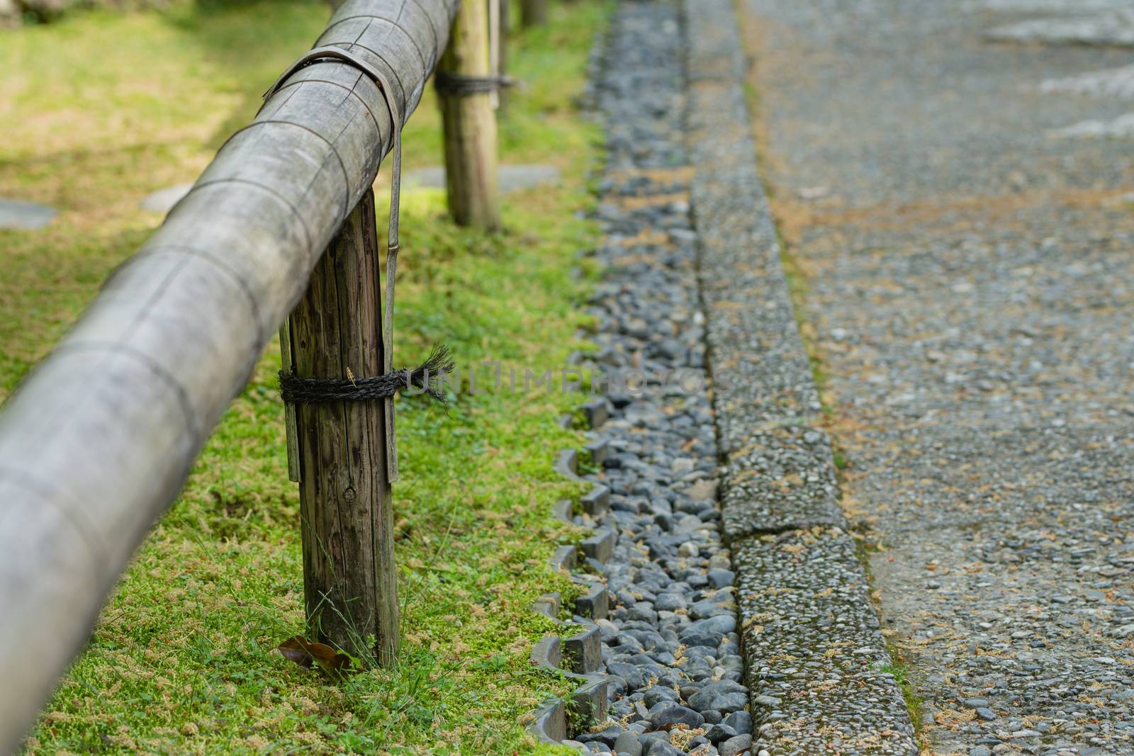 Short Bamboo Fence and Stones along Path by justtscott