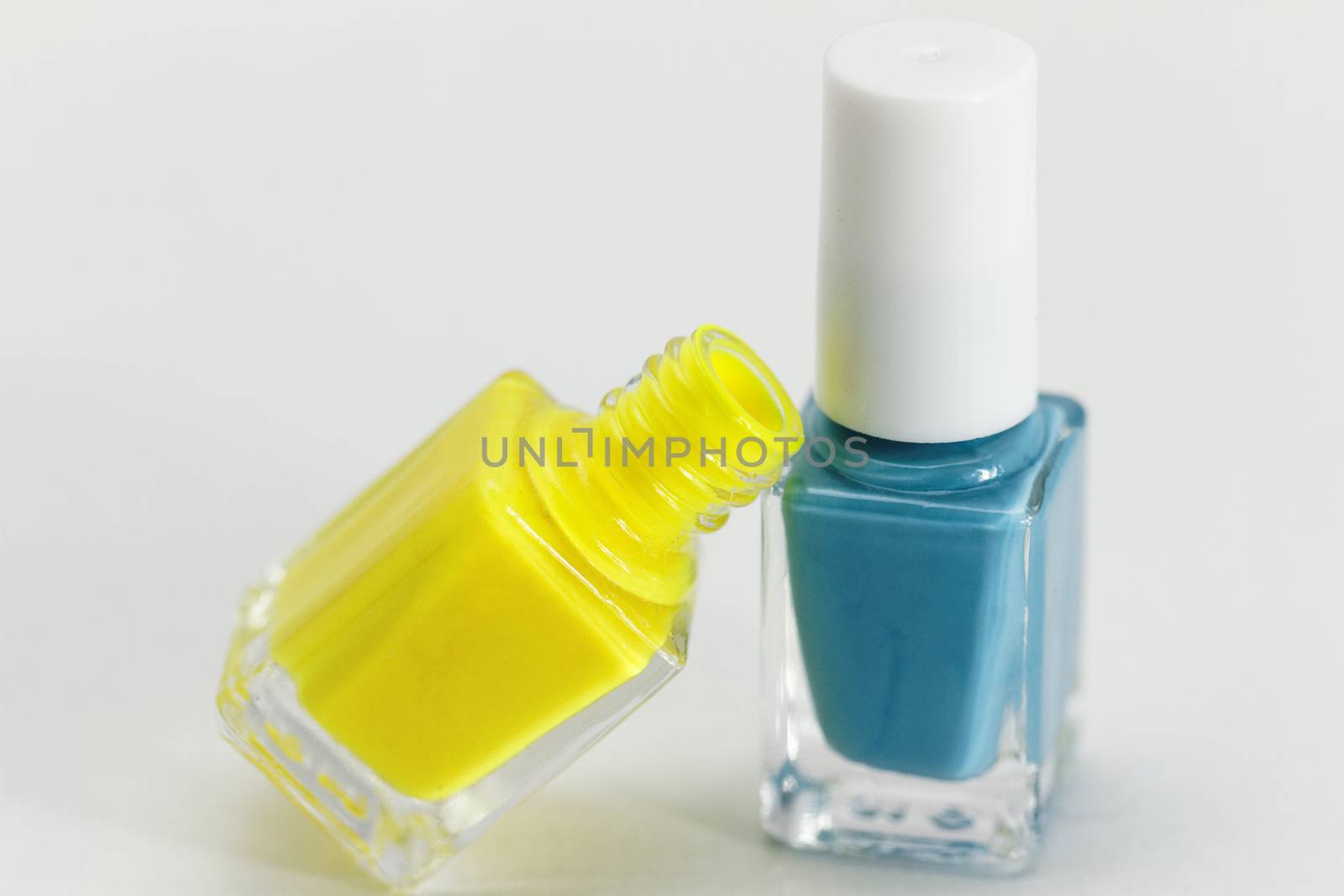 Colorful nail polish - white background, yellow and blue style