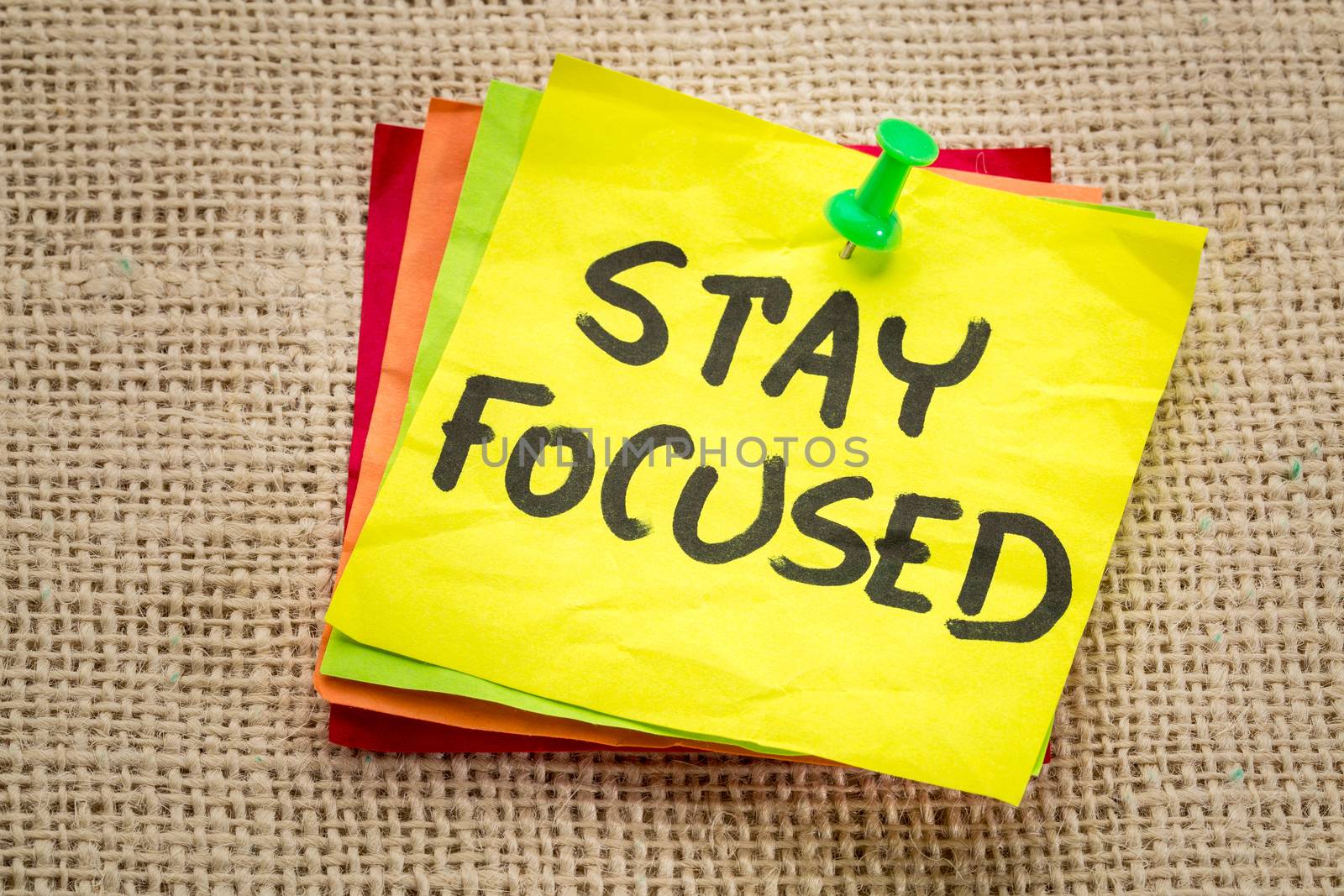 stay focused reminder on a sticky note - motivation concept