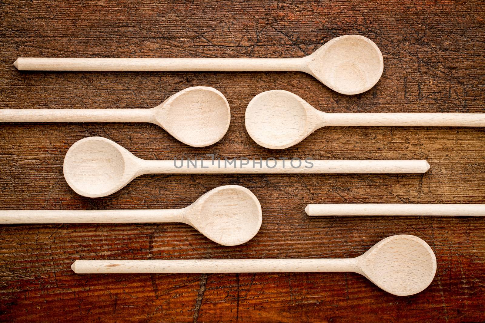 set of empty wooden spoons against grunge rustic wood