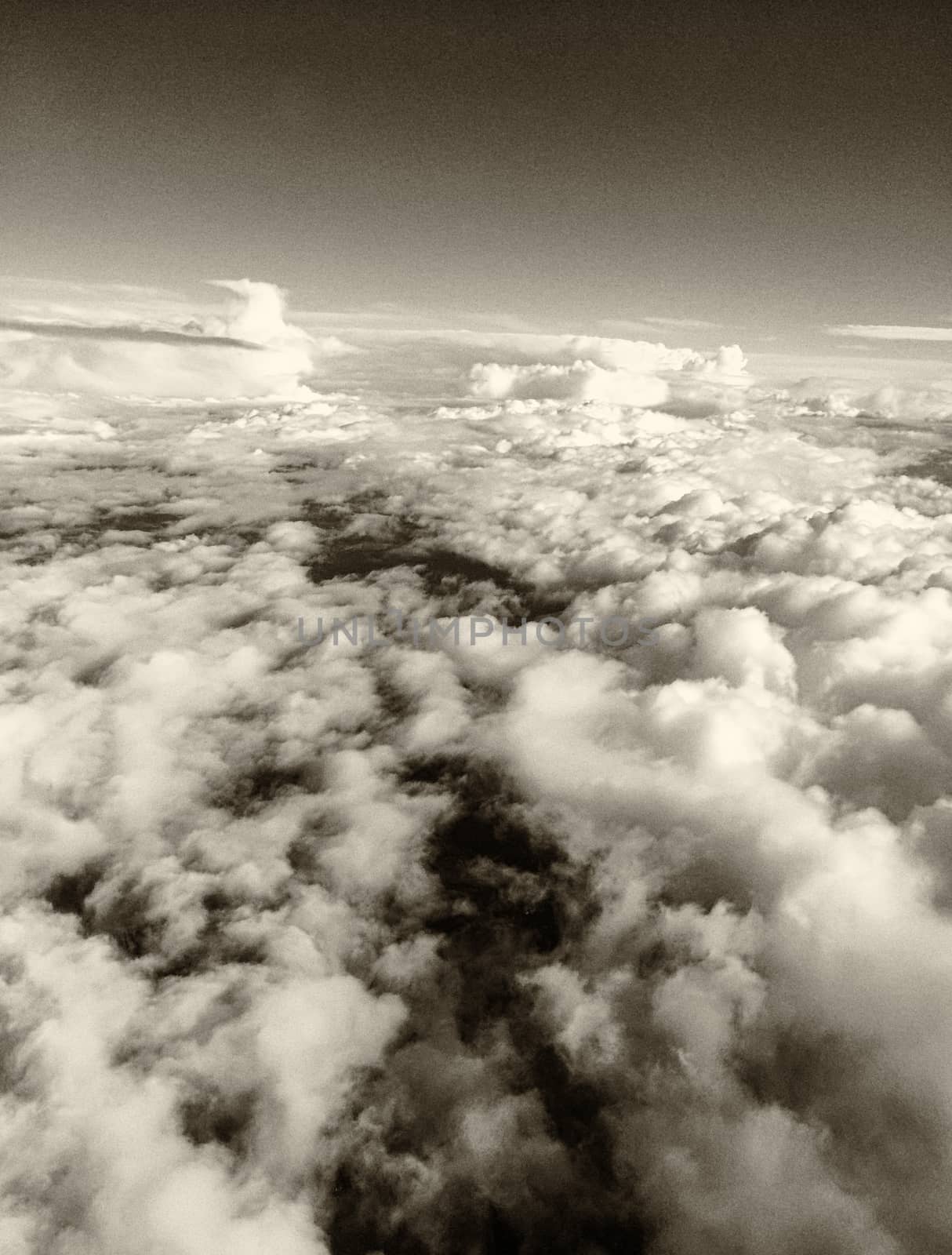 Fluffy clouds in the sky, black and white view from aircaft by jovannig