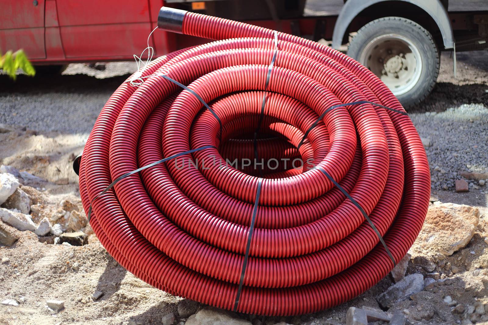 Red colored plastic tube coils on construction site
