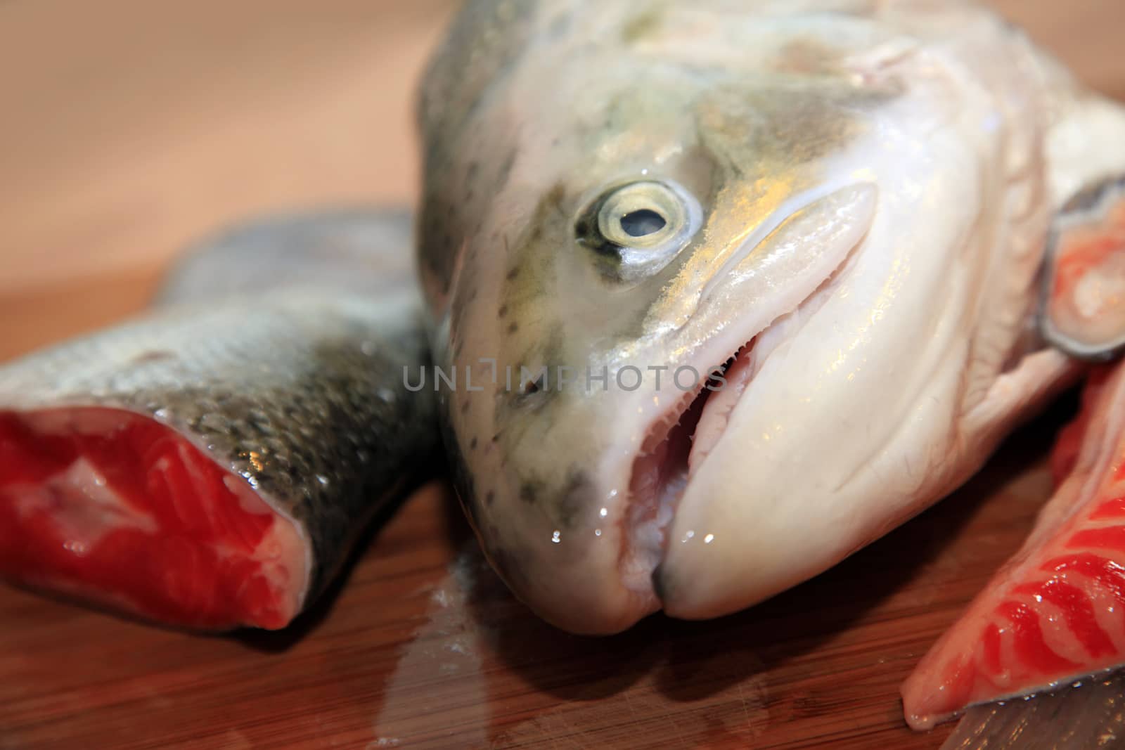 Fresh red salmon fish on wooden cooking desk