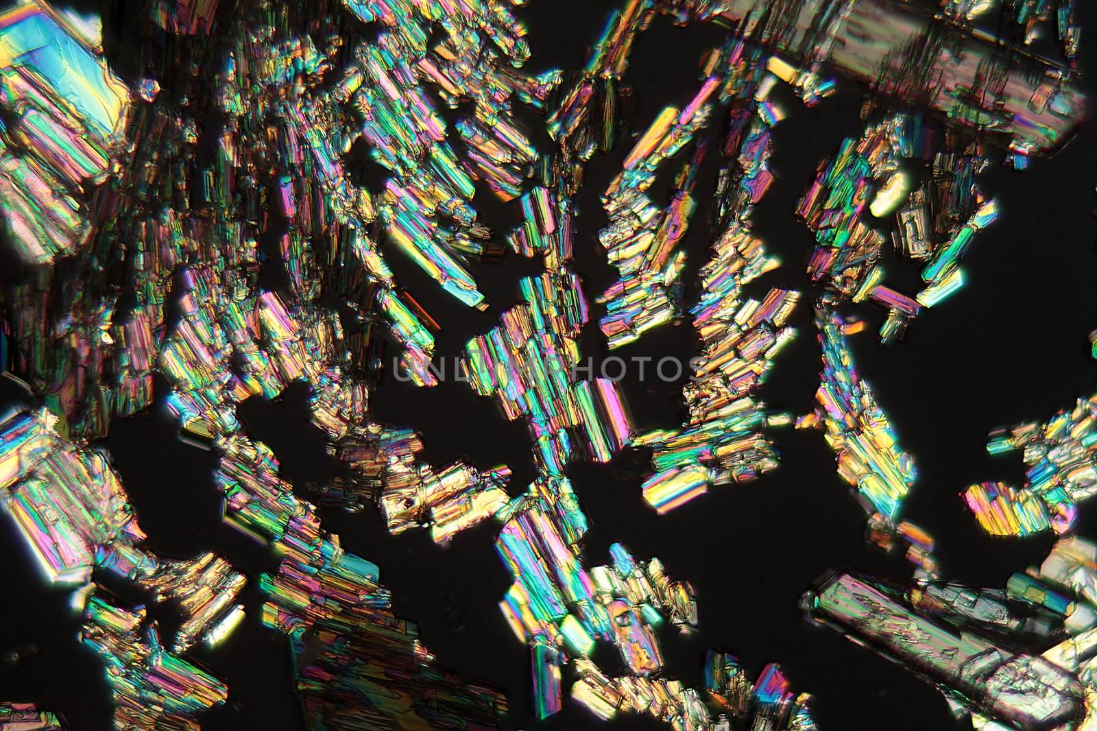 Alanine is a amino acid which occurs in the human body. The photo is made with a magnification of 100x and in polarized light. The sample is pure Alanine precipitated from a solution on a microscope slide.