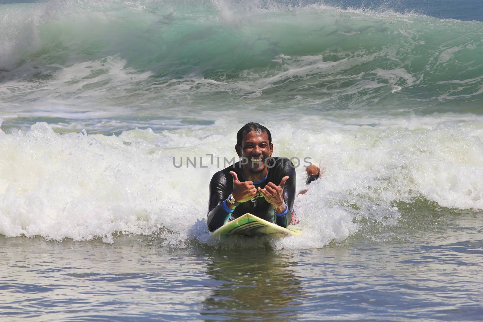 surfer in ocean by friday