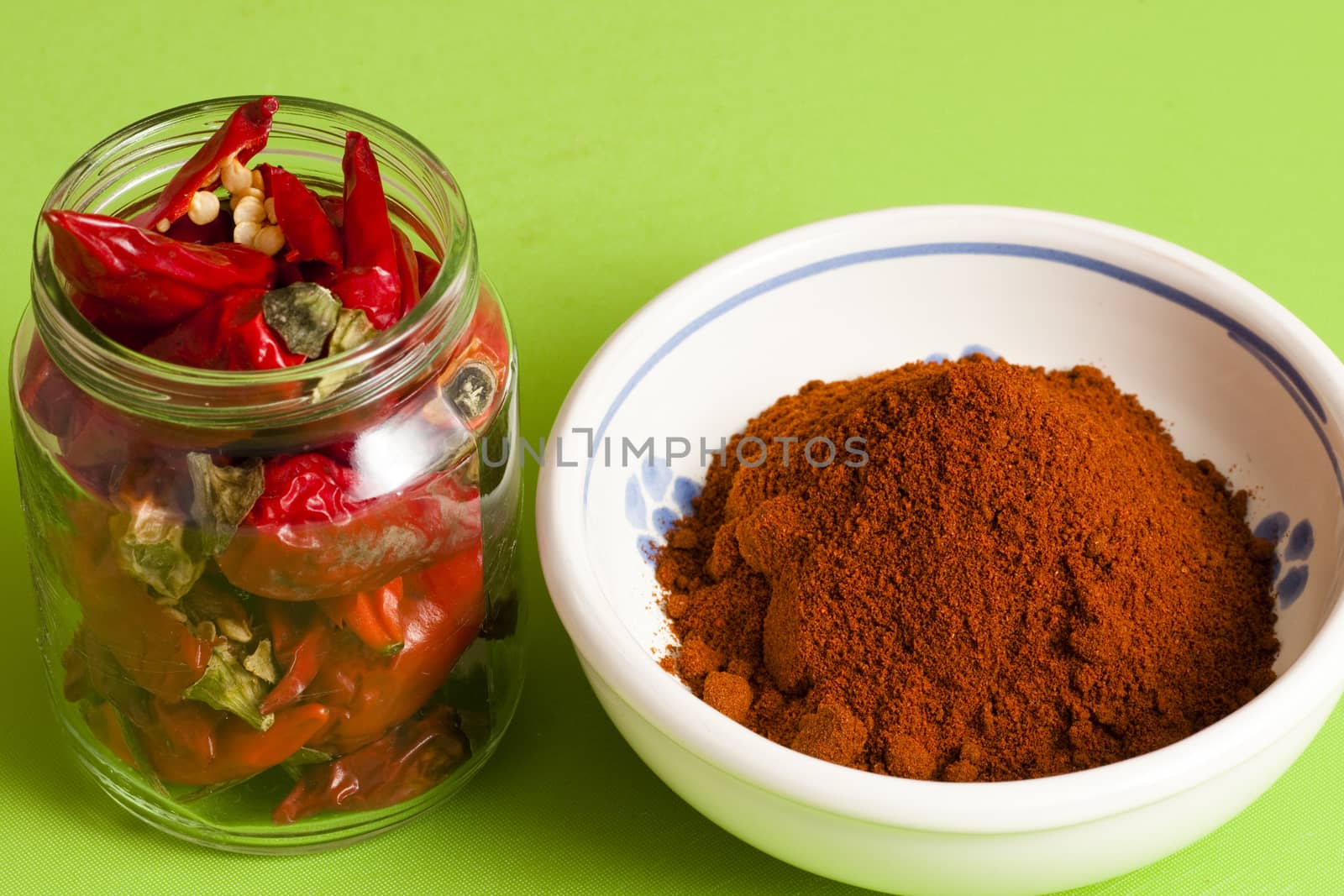 whole red hot chili peppers in a jar and ground