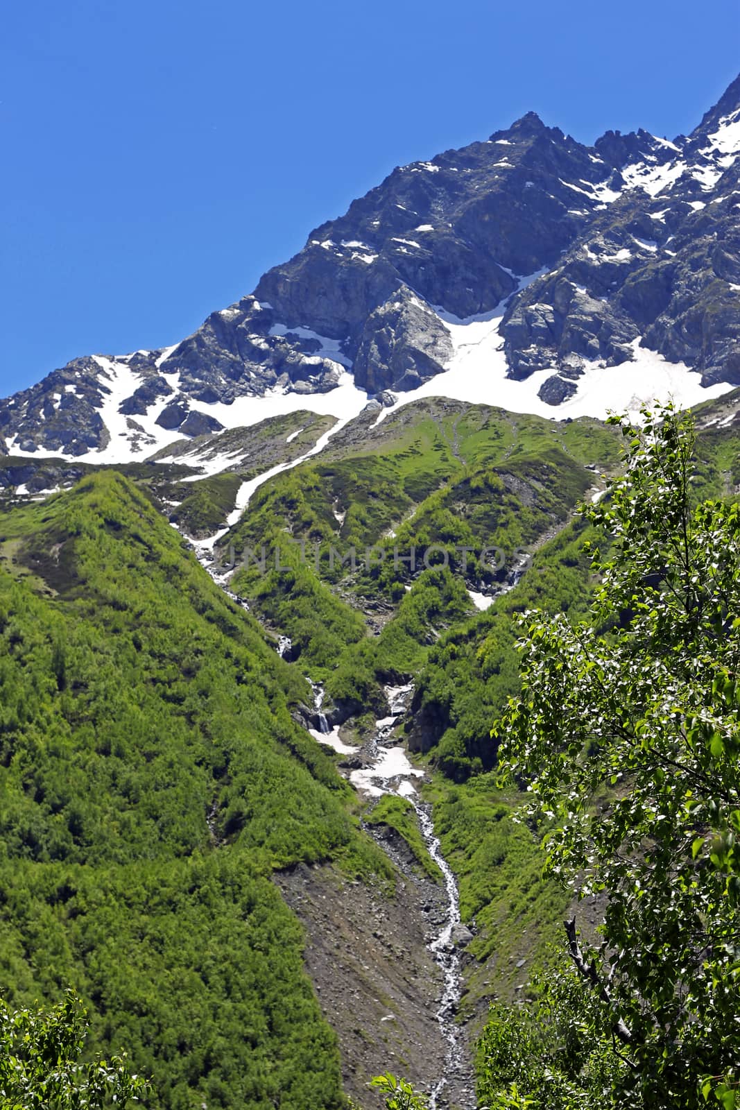 Caucasus Mountains Under Snow And Clear Blue Sky