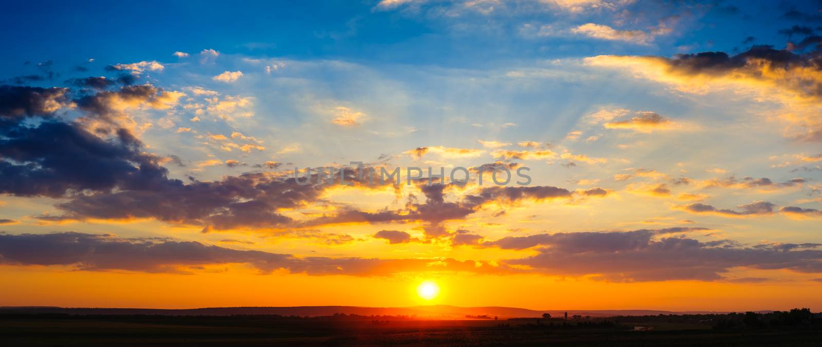 Detailed high resolution colorful dramatic sunset panorama stitched from two horizontal frames