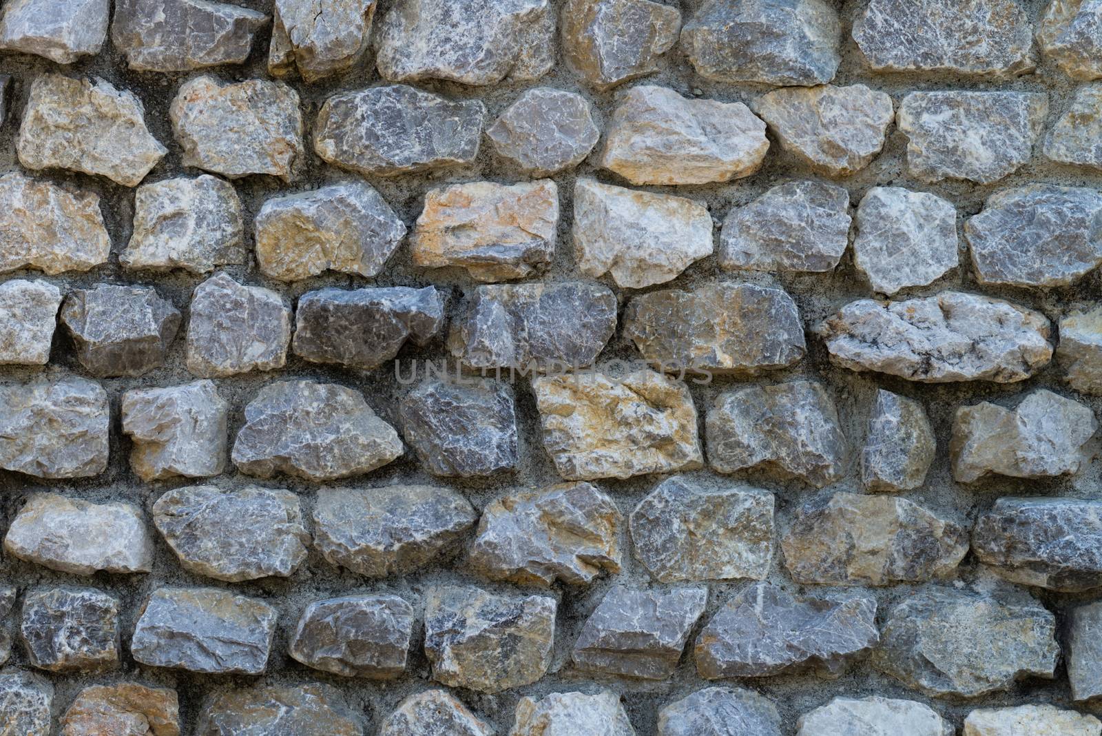 A wall made from many small square stones.