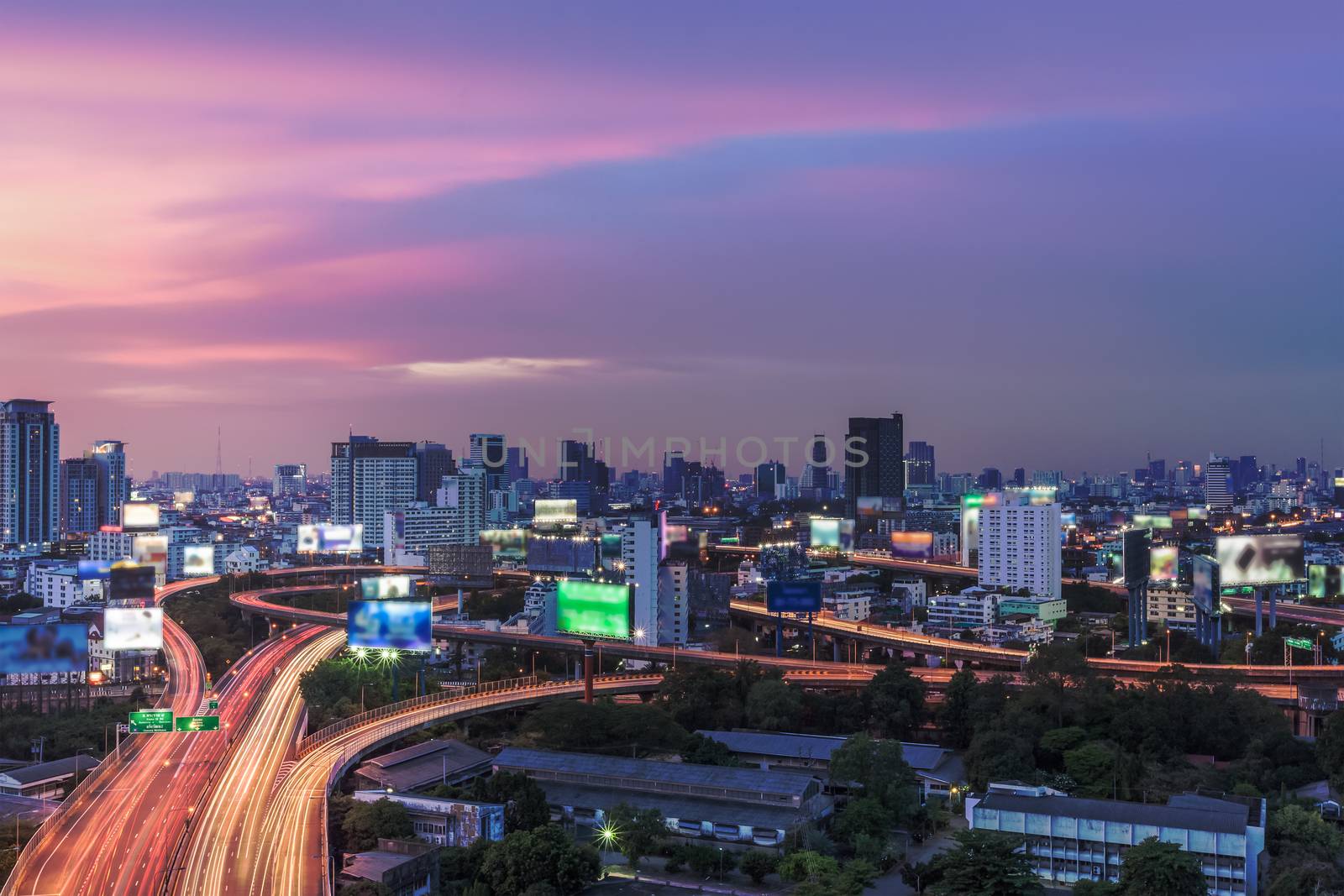 Business Building Bangkok city area at night life with transportation way, logistic concept high angle bird eyes view