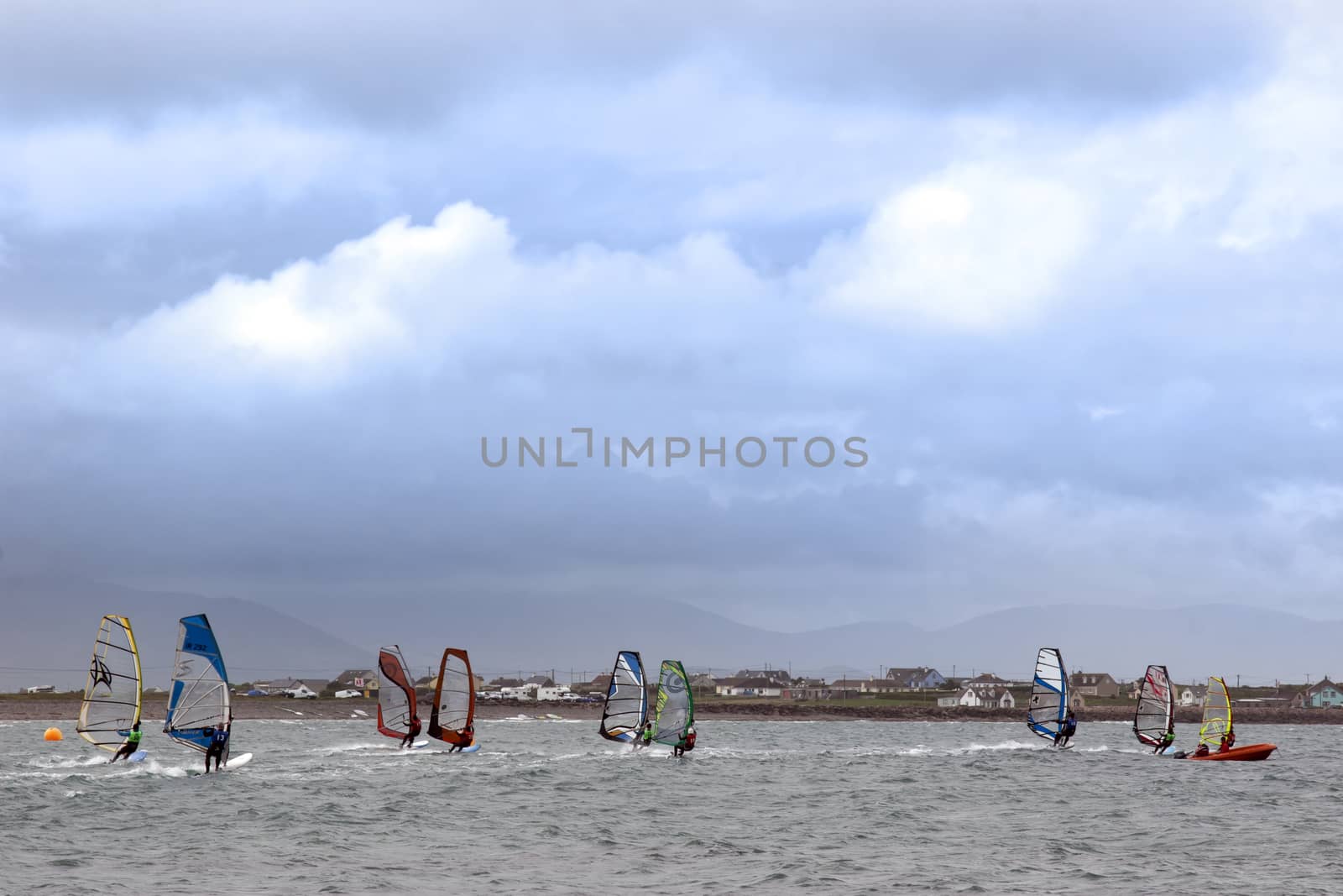 wind surfers racing in the storm winds on the wild atlantic way in county Kerry Ireland