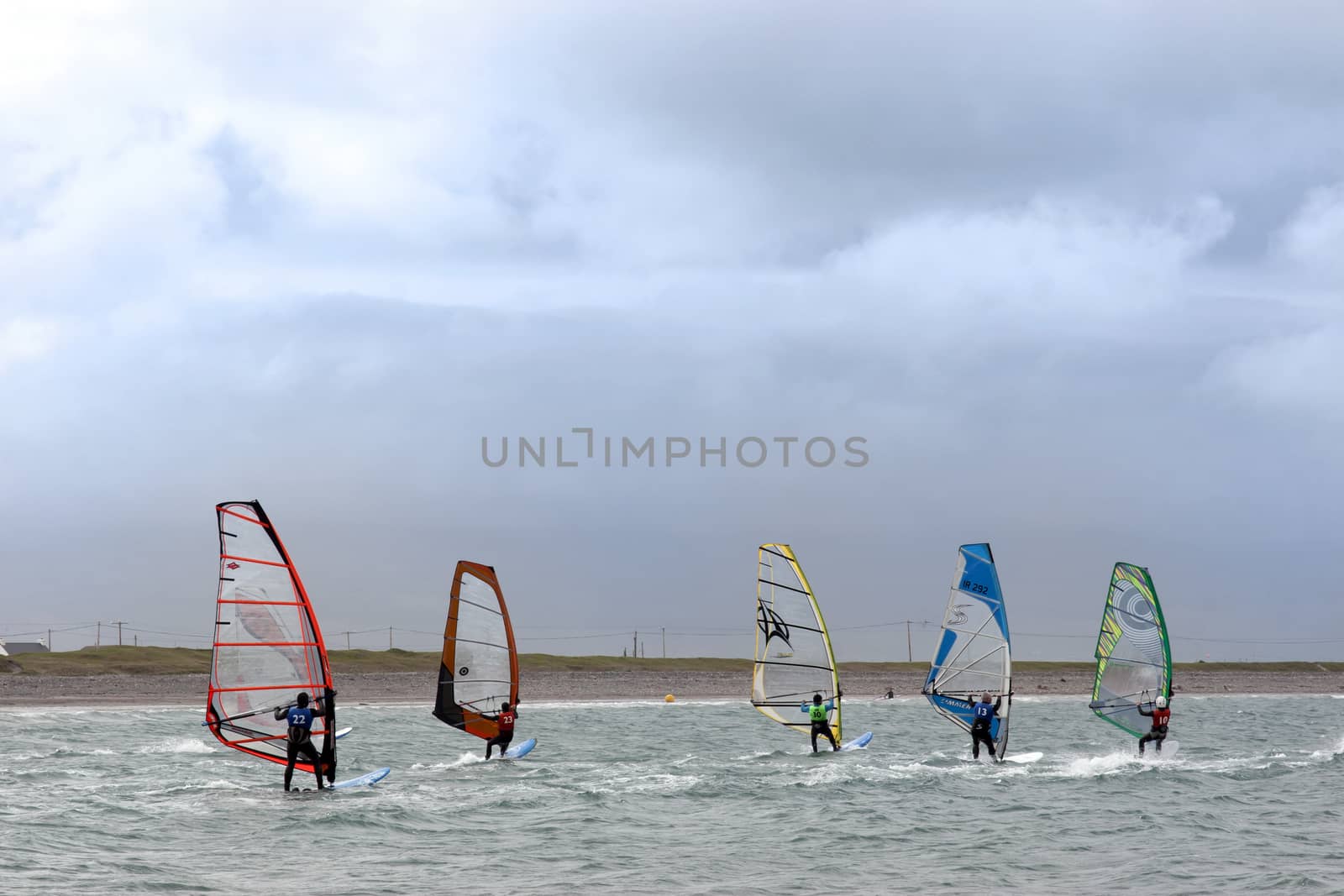 wind surfers racing in the storm winds on the wild atlantic way in county Kerry Ireland