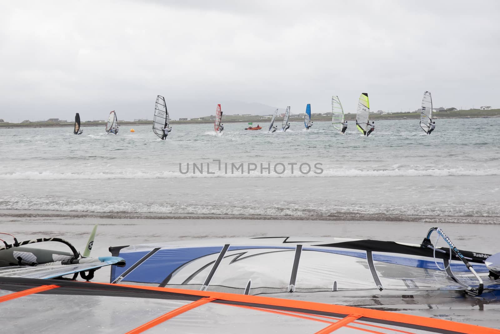 wind surfers racing in the storm winds on the wild atlantic way in county Kerry Ireland