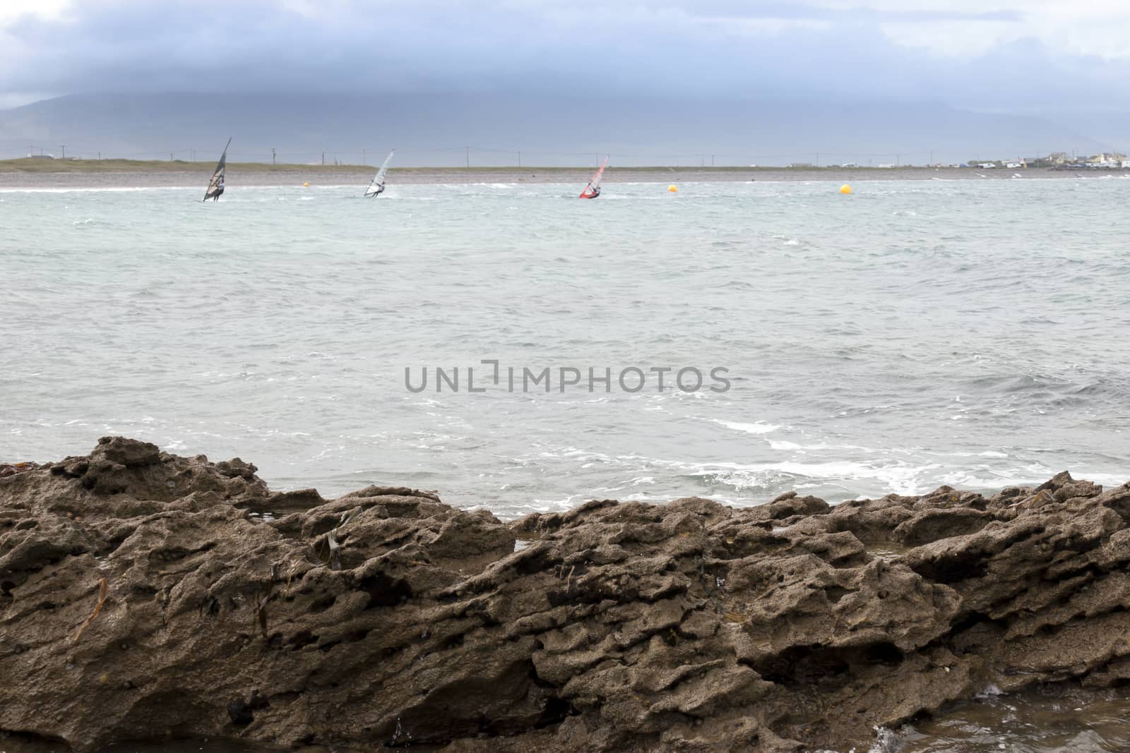 wind surfers braving the storm winds on the wild atlantic way in county Kerry Ireland