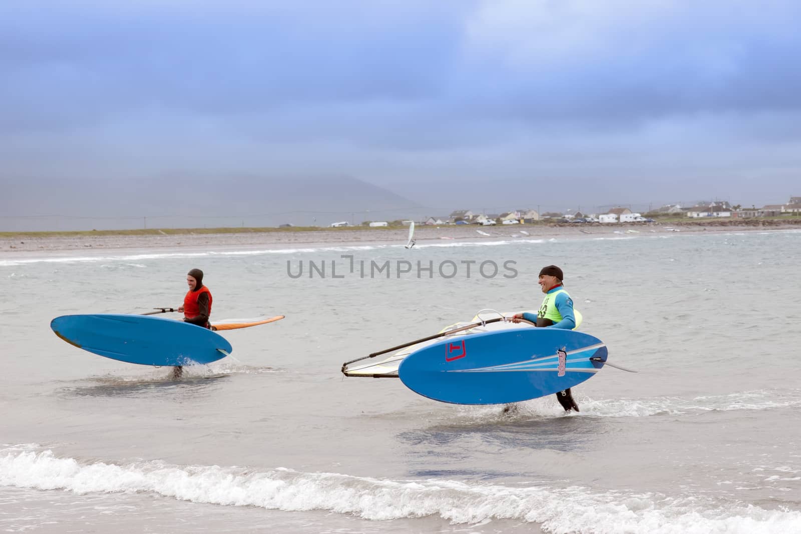 windsurfers finishing up after race and surf on the beach in the maharees county kerry ireland