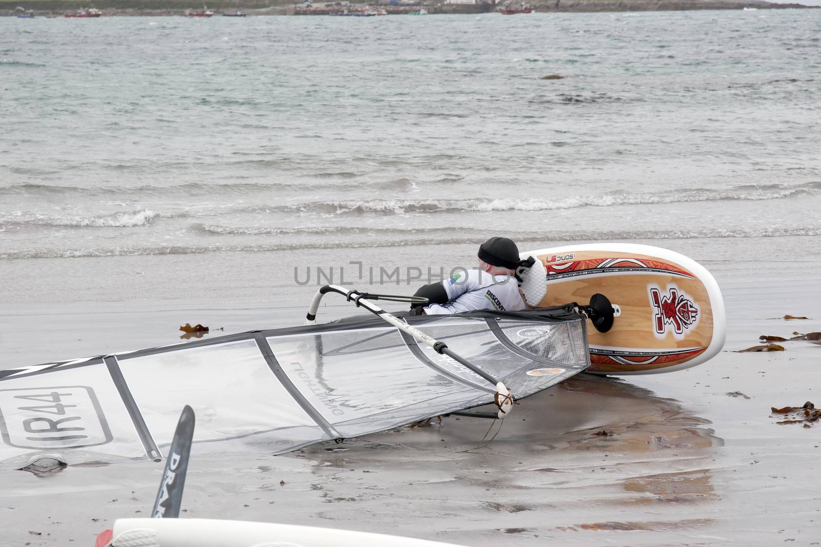 windsurfer having a nap on the beach in the maharees county kerry ireland