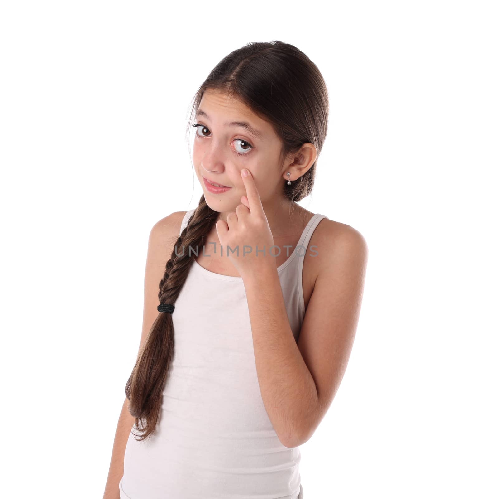 Lovely young girl pointing at her eye. Isolated on white background