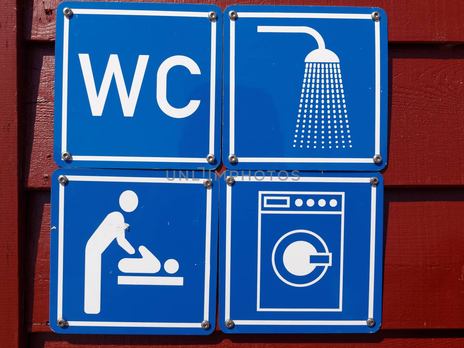 Blue sign of public toilets WC shower washing machines baby changing in a camping site