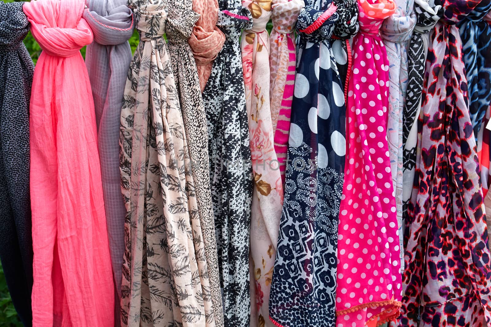 Beautiful colorful scarves hanging  in a fashion accessories shop                               