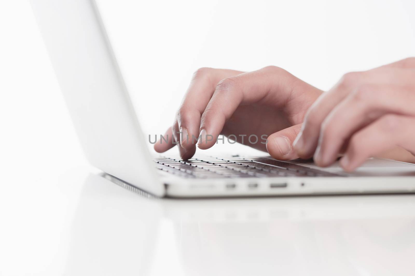 Closeup of Fingers Using Laptop Keyboard