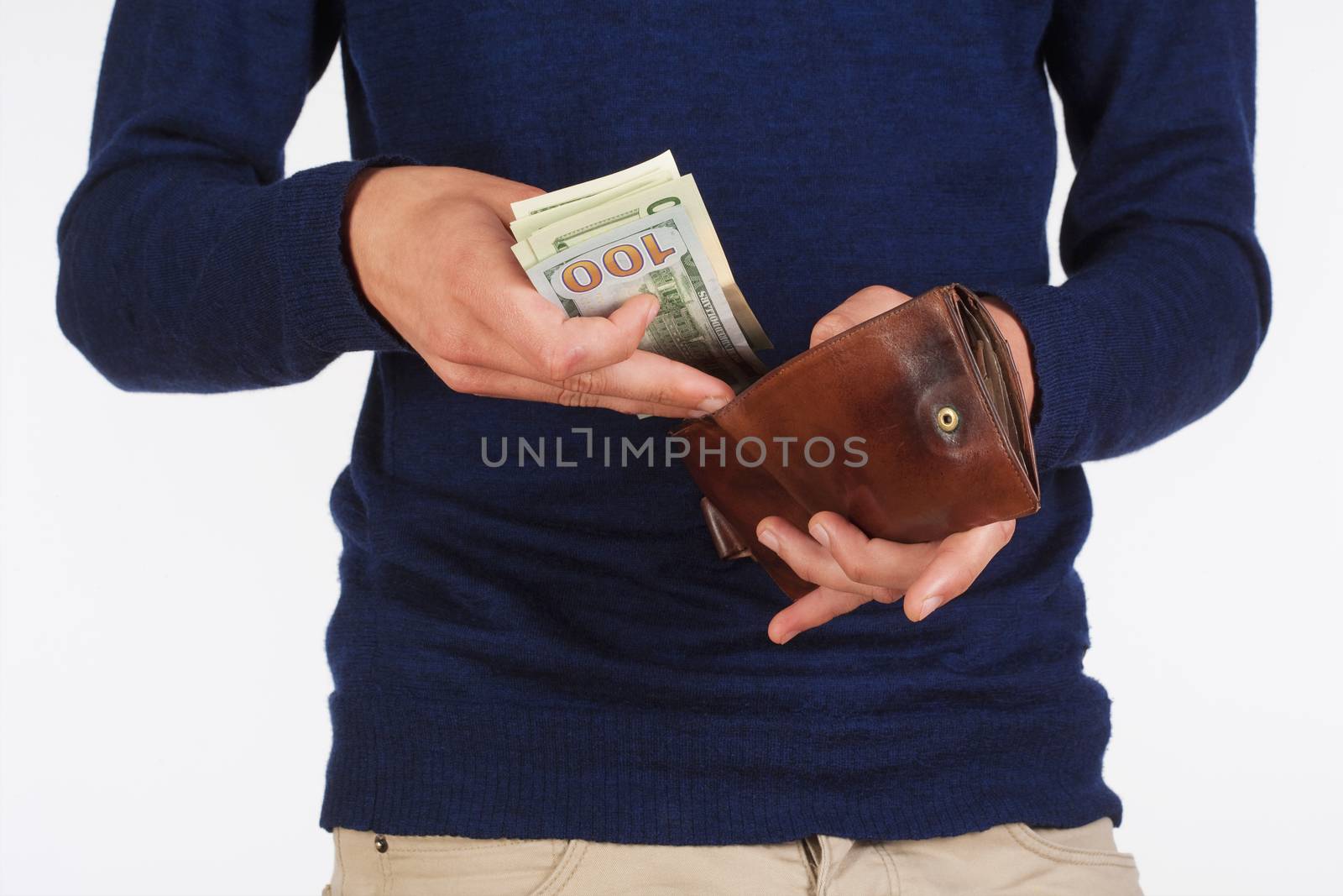 Man Holding a Wallet and Counting Dollars by courtyardpix